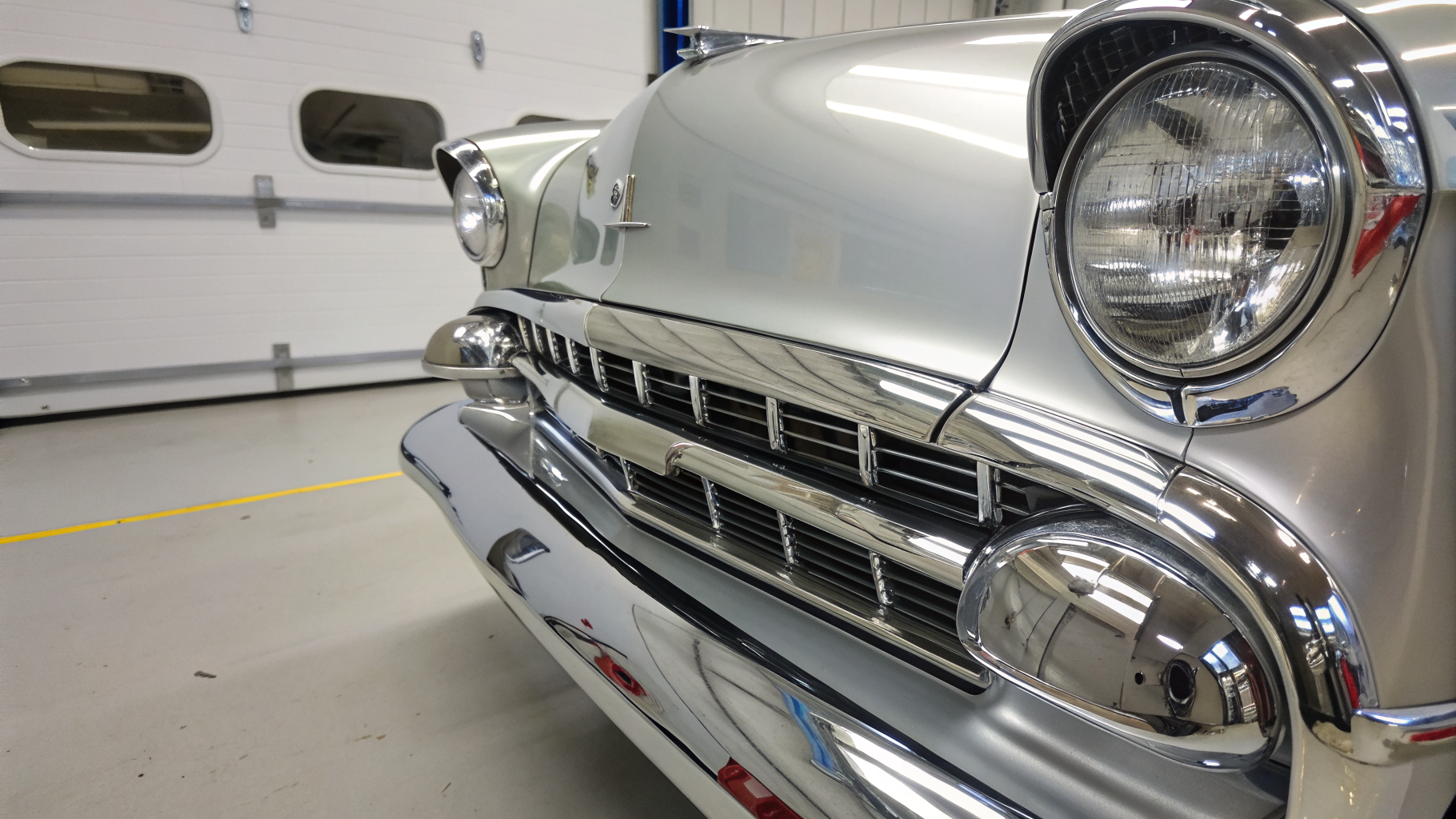 Freshly re-chromed classic car bumper with a mirror finish after automotive chrome plating