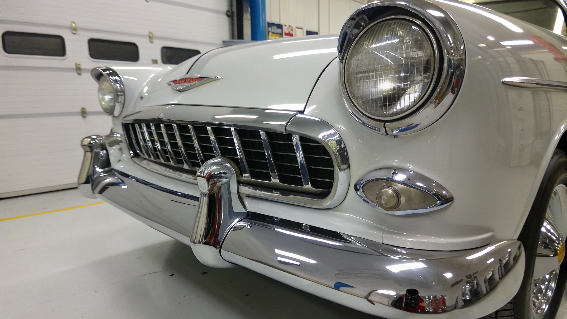 Freshly re-plated classic car bumper with a mirror chrome finish after restoration