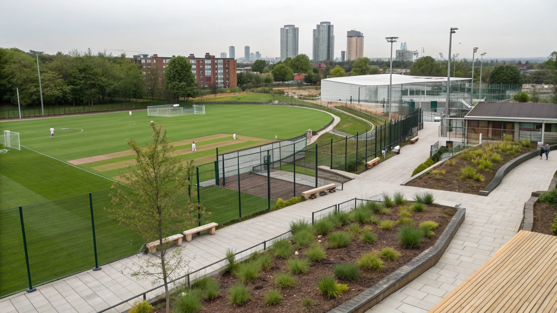 Modern landscaping workshop facility with artificial grass rolls, composite decking materials, and natural stone paving samples displayed in Birmingham