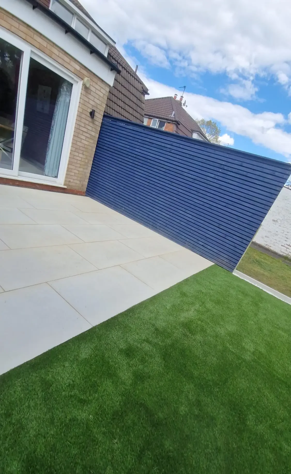 Sleek Patio and Turf with Blue Fencing