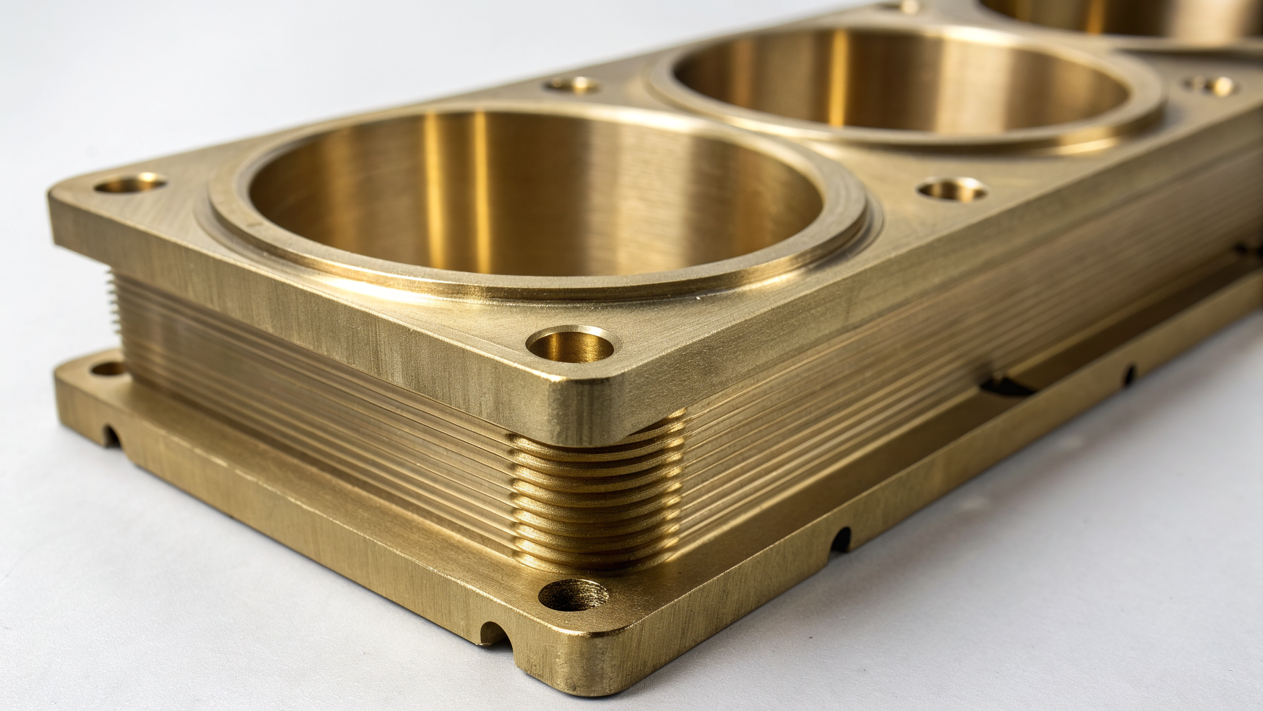 Close-up of a precision brass-plated architectural component showing a smooth, consistent finish